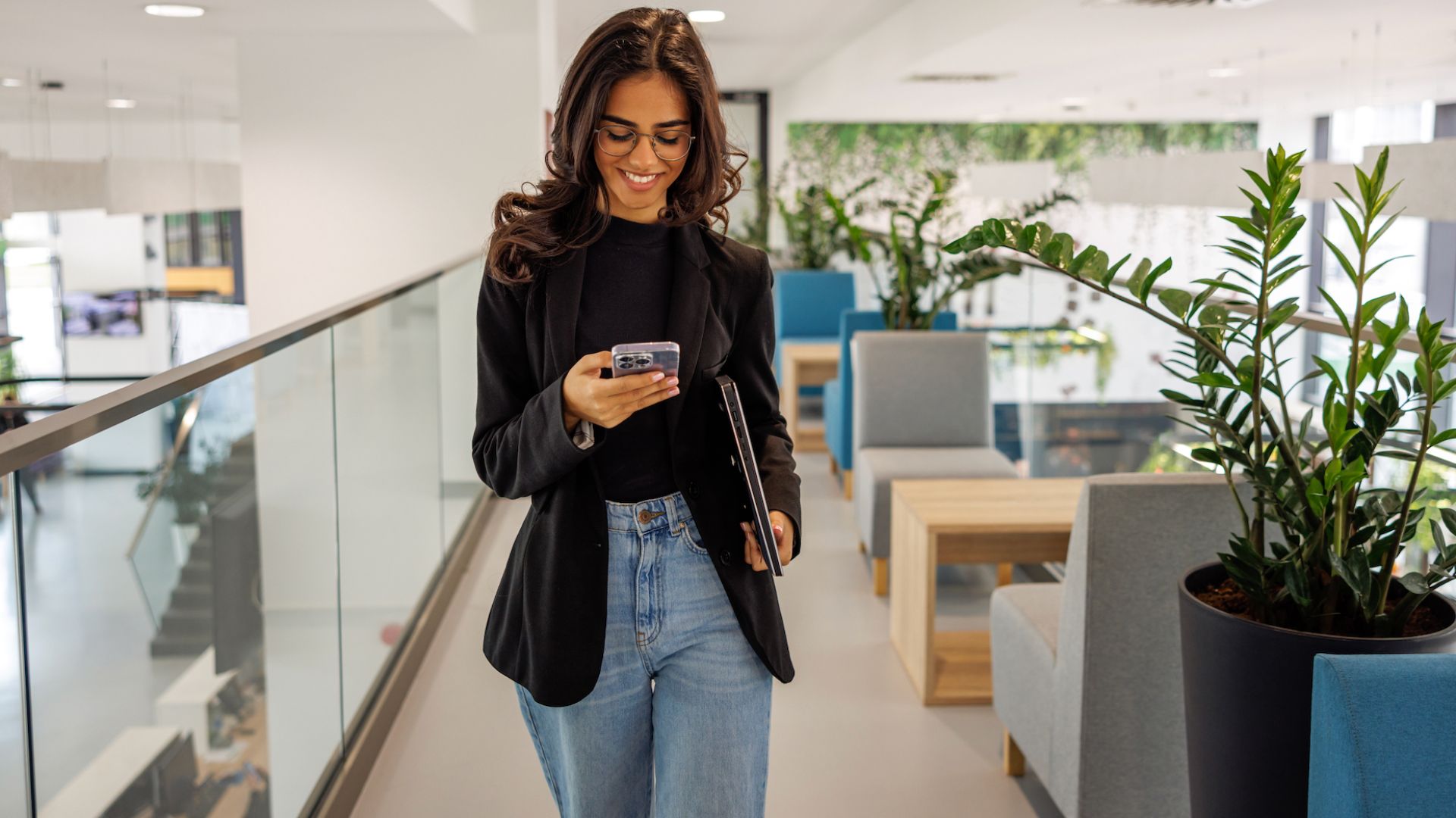 A Woman using a smart at one of the best companies in Uk